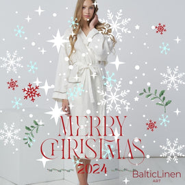 A woman in a white linen robe surrounded by Christmas snowflakes, wishing you a cozy and bright holiday season.